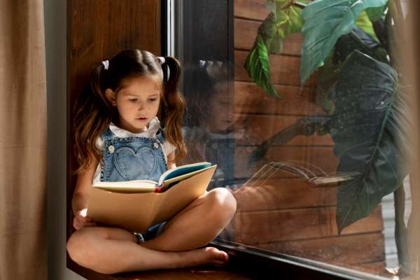 Child practicing reading at home 