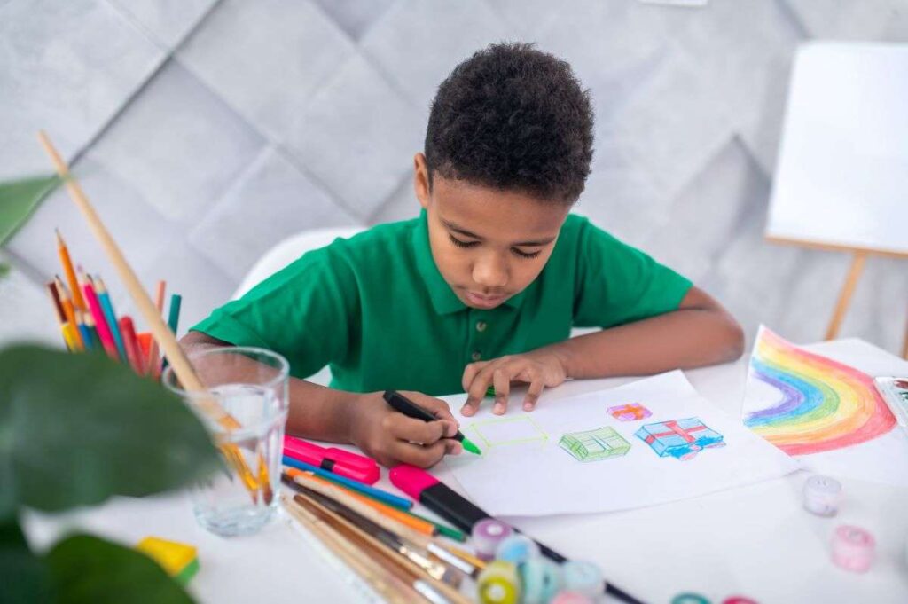 A child sitting upright at a desk, demonstrating the correct posture and pencil grip for efficient handwriting.