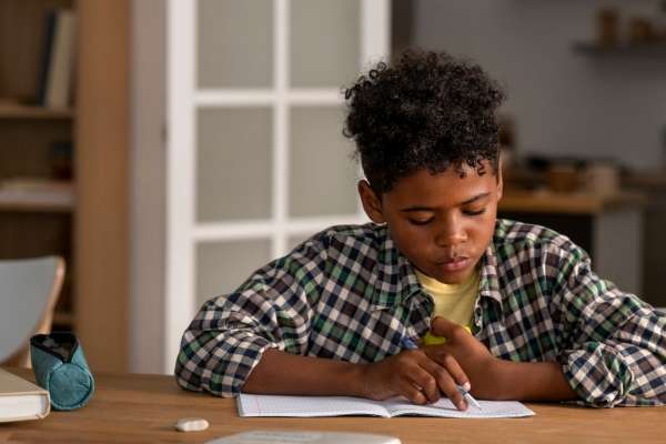 Child using a pen as a pacer while reading.