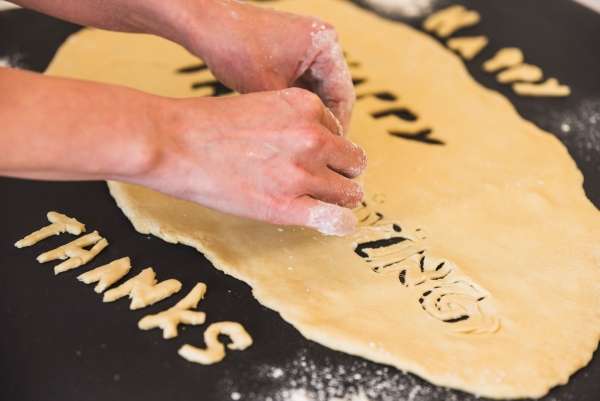 Engaging in a hands-on reading activity, forming words with dough, illustrating how multi-sensory approaches can enhance decoding practice.