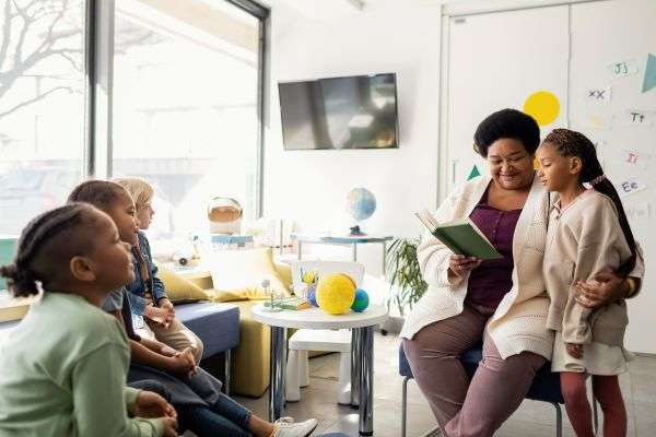 A female teacher helping a child with syllable mastering