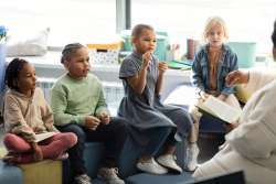 A teacher teaching children about rhyming words.