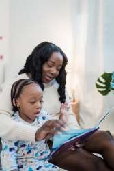 A parent helping her child with reading fluency.