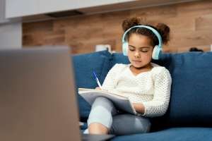 A child enjoying listening comprehension from an audio book