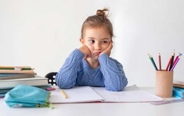 A frustrated child struggling with reading
 