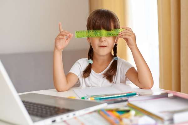 Child playing with a ruler as one of Everyday Objects to Help Your Preschooler