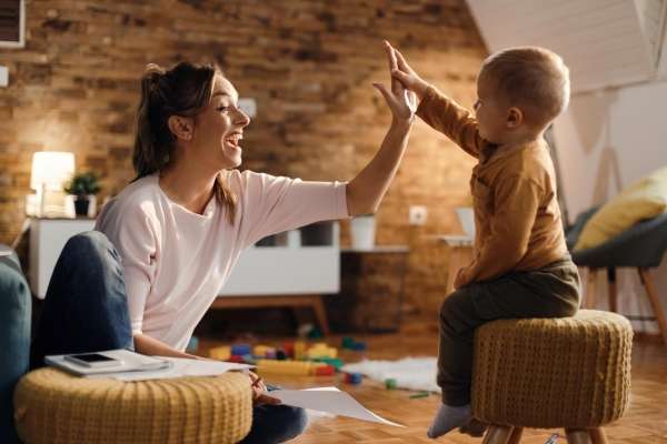 Mother giving her son a a high five