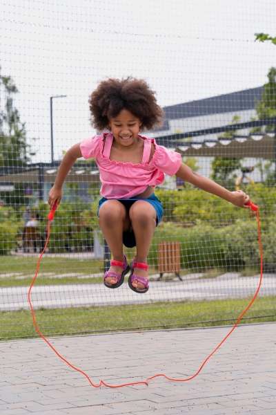 Preschooler jumping a specified number of times to practice Numeracy.