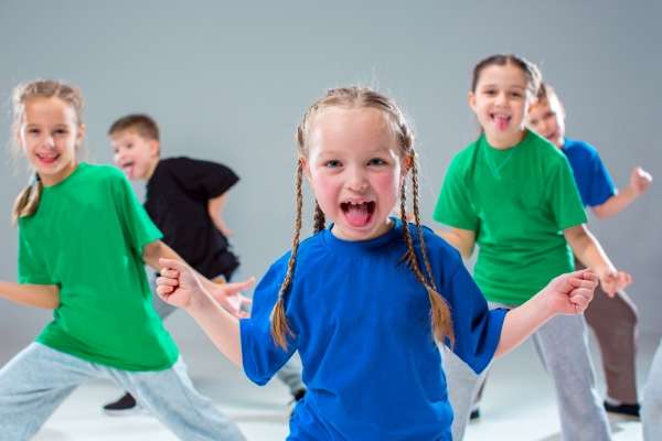 Children performing a dance sequence.