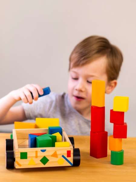 Preschoolers building towers with blocks. Blocks are easy to make math fun and interactive