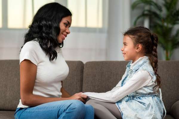 Mother talking to her daughter.