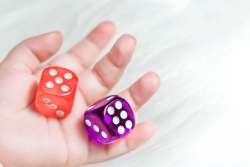 Child's hands holding dice. A great way to help understand probability concept.