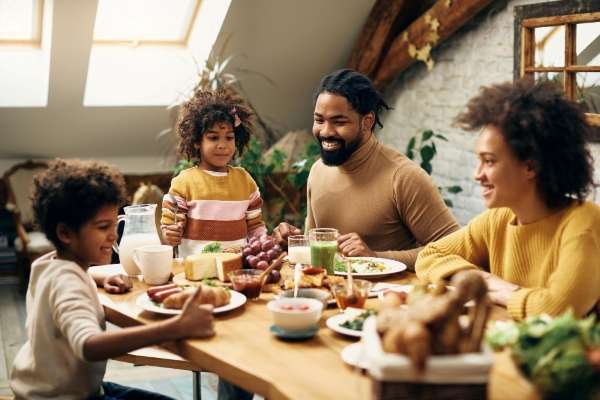 A family enjoying delicious dinner which is a great time to teach basic time concepts.