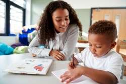 Mom and child drawing a colorful bar graph together to learn basic statistics concepts.