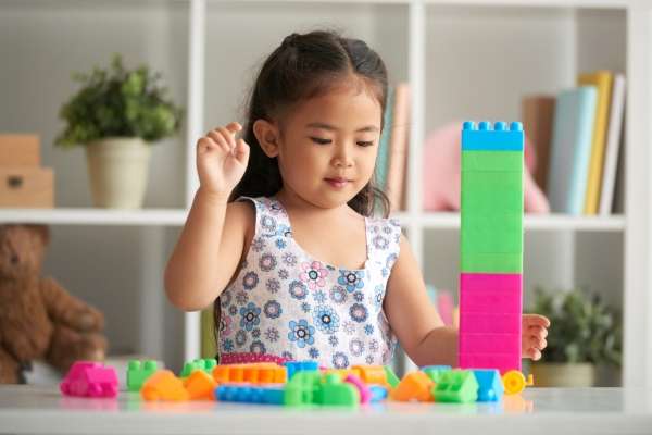 Assortment of colorful blocks, arranged and sorted by color by a child learning the sorting and classifying concept.