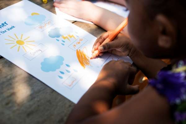 A child learning data collection and analysis by observing the weather.