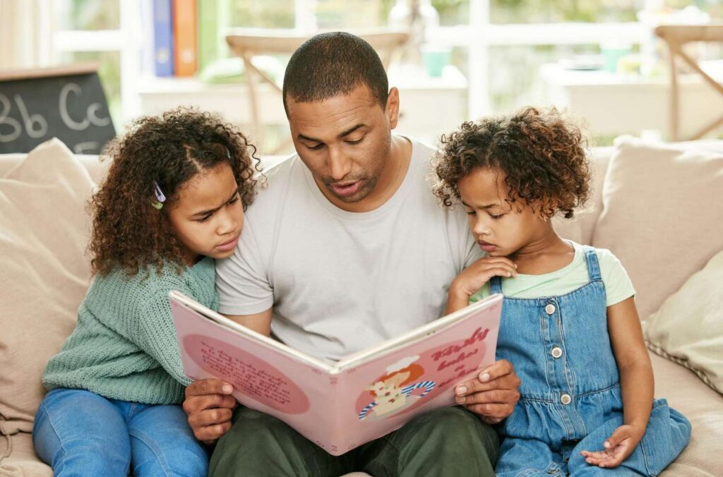 Parent and child engaged in reading a money-themed book.