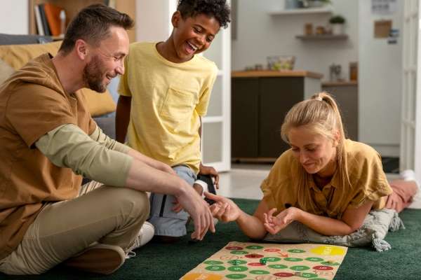 Family playing a board game for number learning.