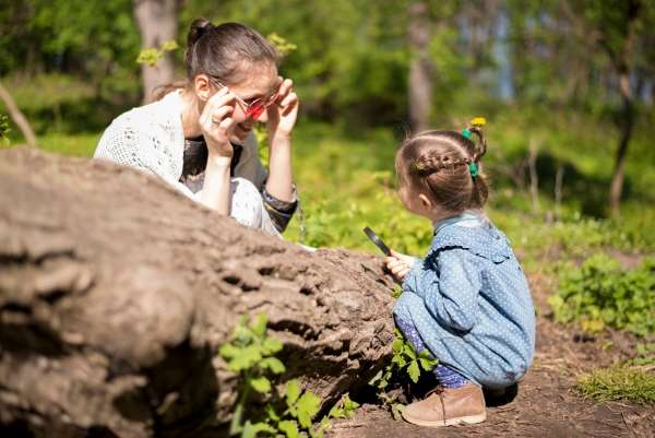 Mother and child exploring nature and learning.