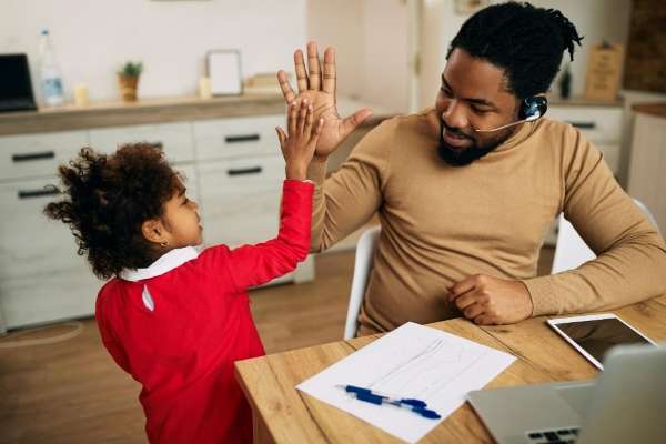 Child and parent giving and counting high fives.