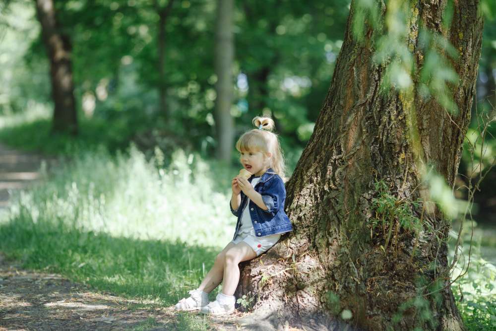 A child enjoying ice cream and learning trees. placing on rock on each tree to learn one on one correspondence
