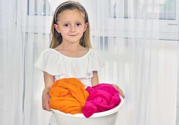 Child matching linens from a laundry basket as she learns the sorting and the classification concept.