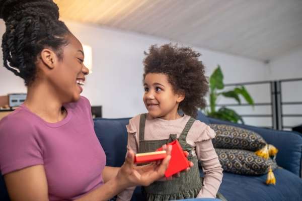 Mother gifting a child.