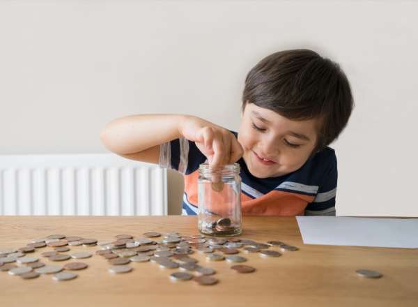 Child comparing values of different coins.