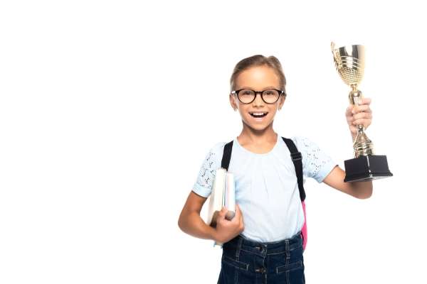 Close-up of a child's hands holding a small trophy for math -winning basic numeracy problem-solving