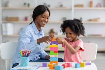 Mother and child learning how to build with building blocks,