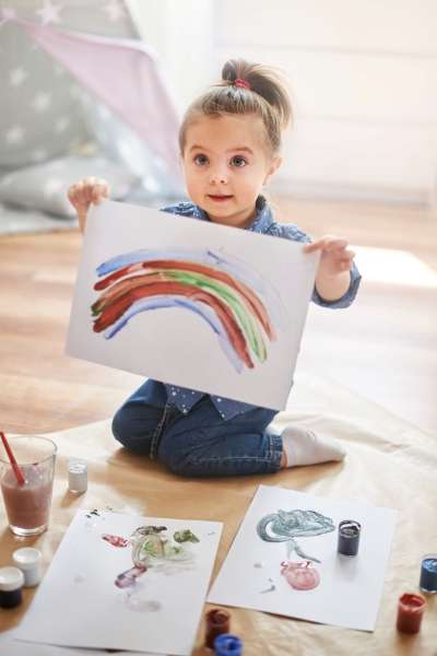 beautiful girl learning how to create unique artwork through paint mixing