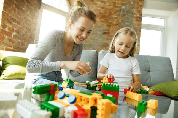 Mother and child sorting out blocks as a way to learn how to build using building block